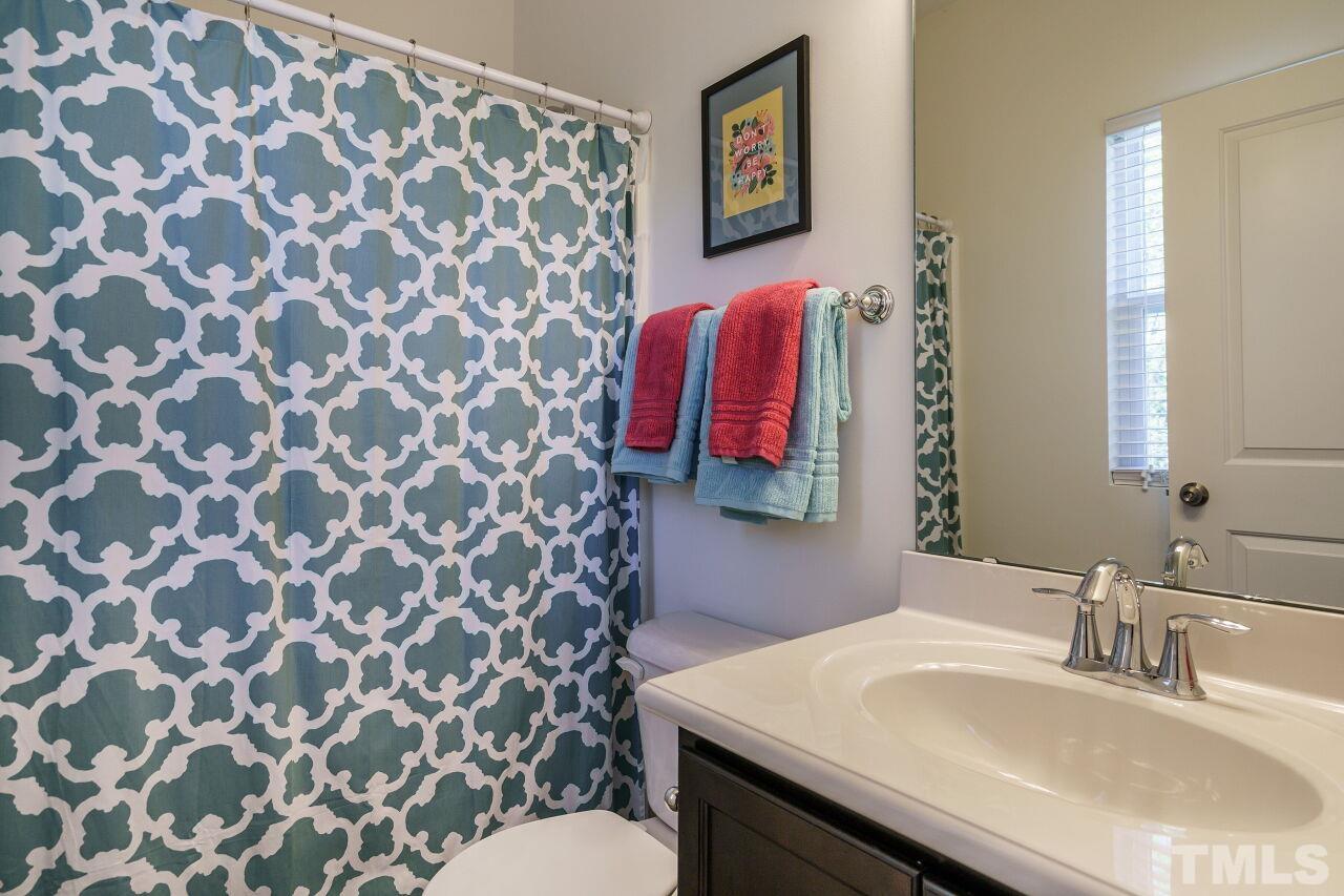 1533 Crafton Way Raleigh, NC 27607 - Photo 22 of 28 a bathroom with a sink and a mirror