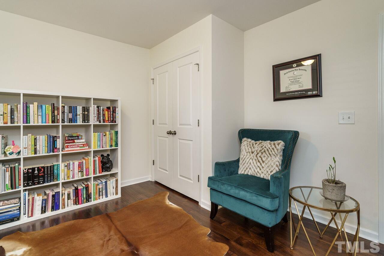 1533 Crafton Way Raleigh, NC 27607 - Photo 25 of 28 a living room with furniture and a book shelf
