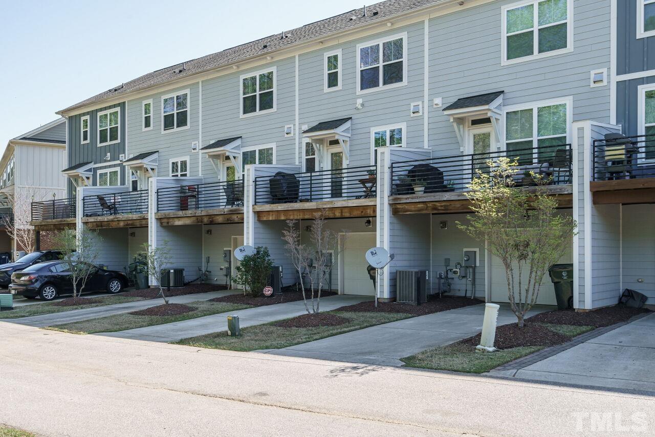 1533 Crafton Way Raleigh, NC 27607 - Photo 27 of 28 a front view of a building with a garden and parking