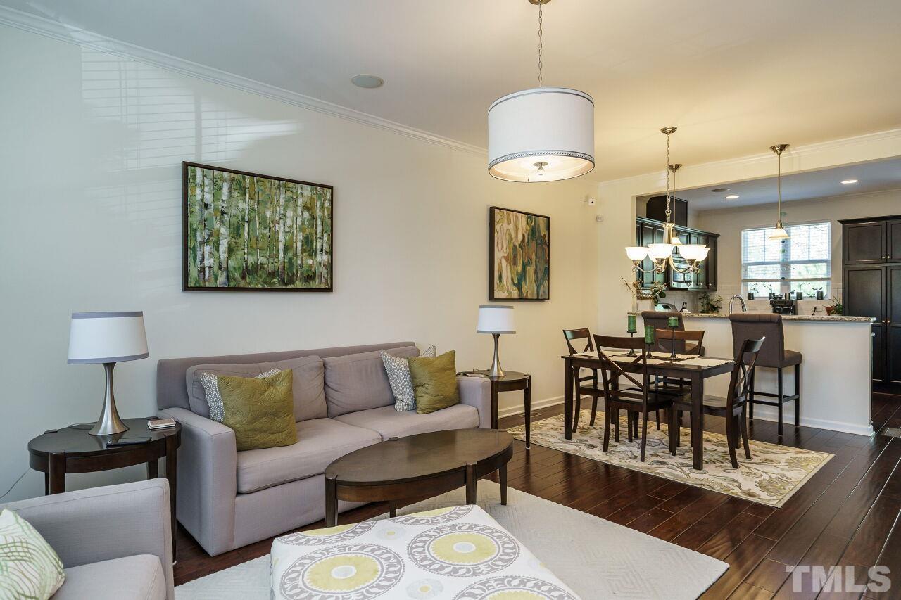 1533 Crafton Way Raleigh, NC 27607 - Photo 5 of 28 a living room with furniture a rug and a chandelier