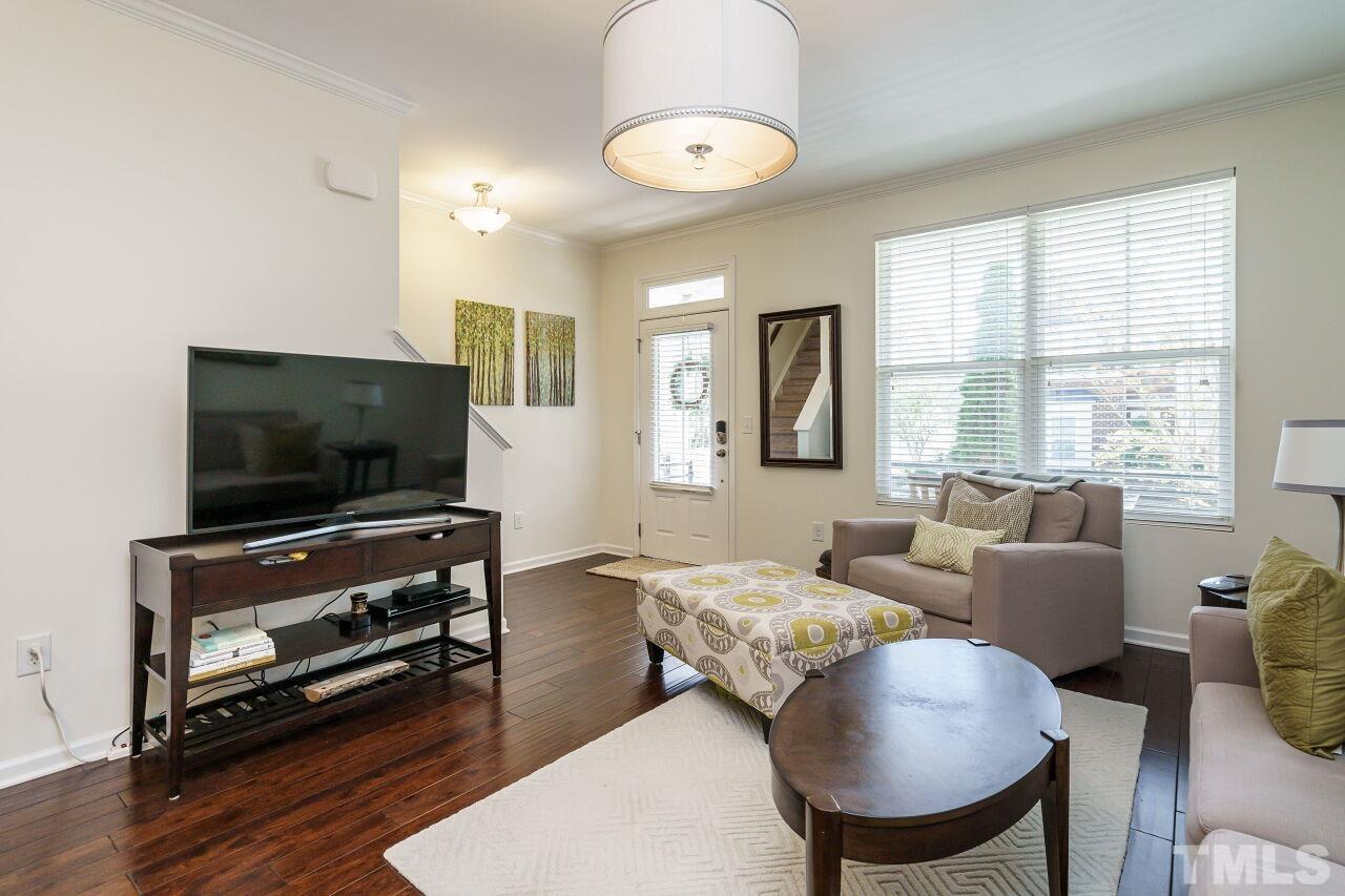 1533 Crafton Way Raleigh, NC 27607 - Photo 8 of 28 a living room with furniture and a flat screen tv
