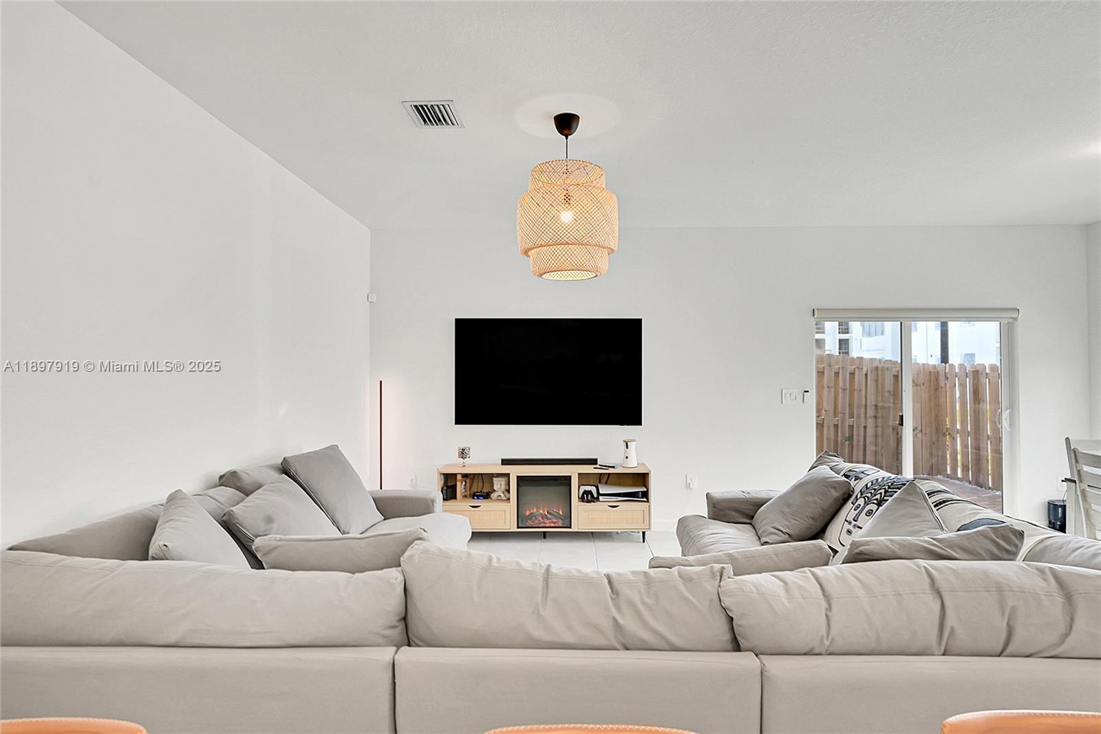 14832 Southwest 265th Street Homestead, FL 33032 - Photo 12 of 43 a living room with furniture and a flat screen tv