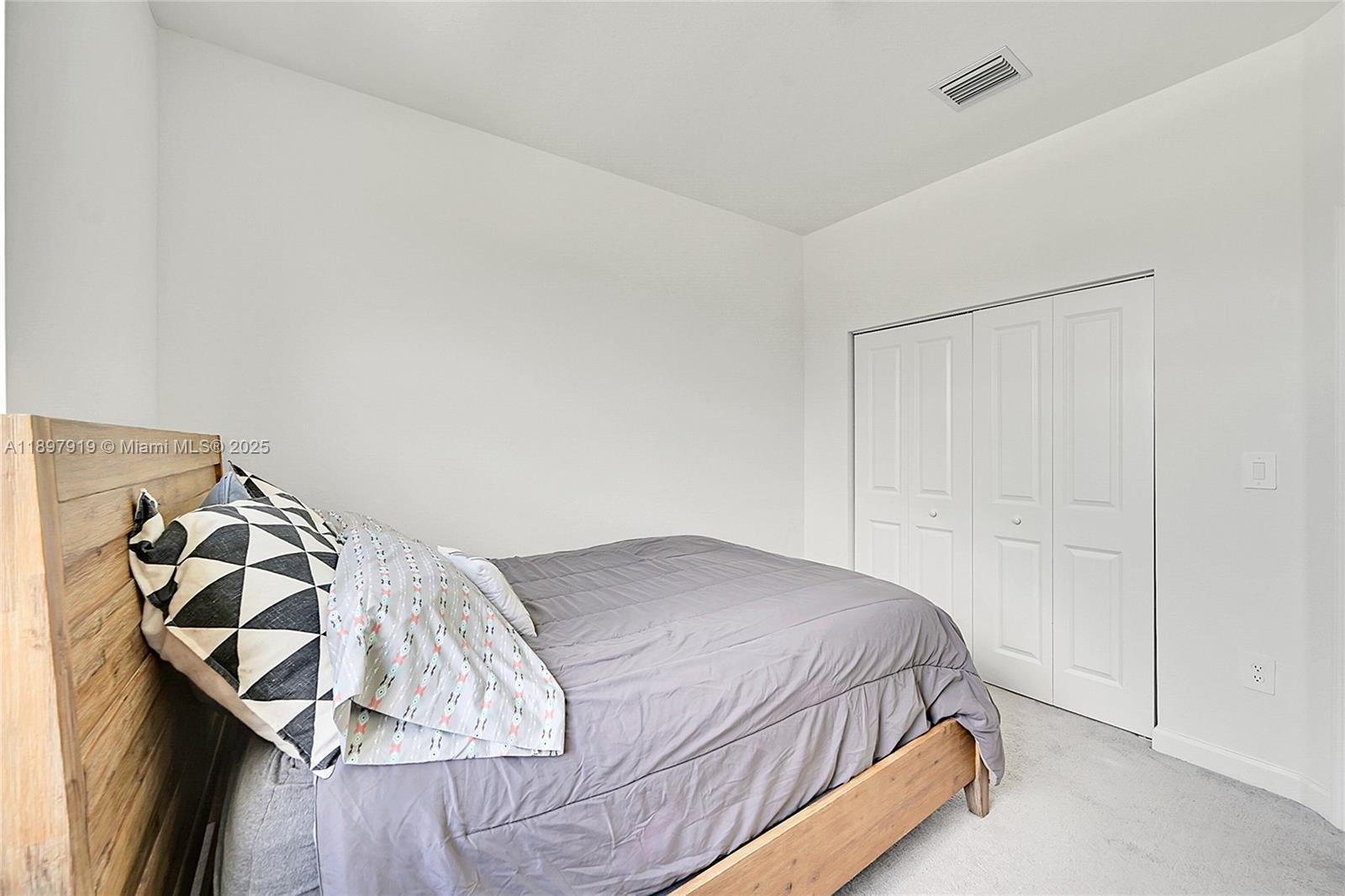 14832 Southwest 265th Street Homestead, FL 33032 - Photo 29 of 43 a bedroom with a bed and a window