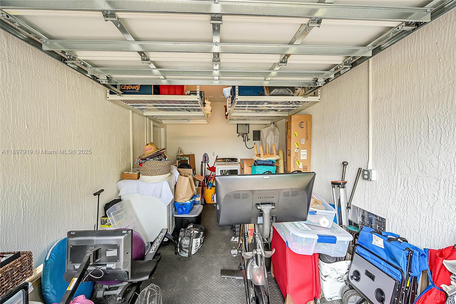 14832 Southwest 265th Street Homestead, FL 33032 - Photo 36 of 43 a view of storage and utility room with racks a book shelf