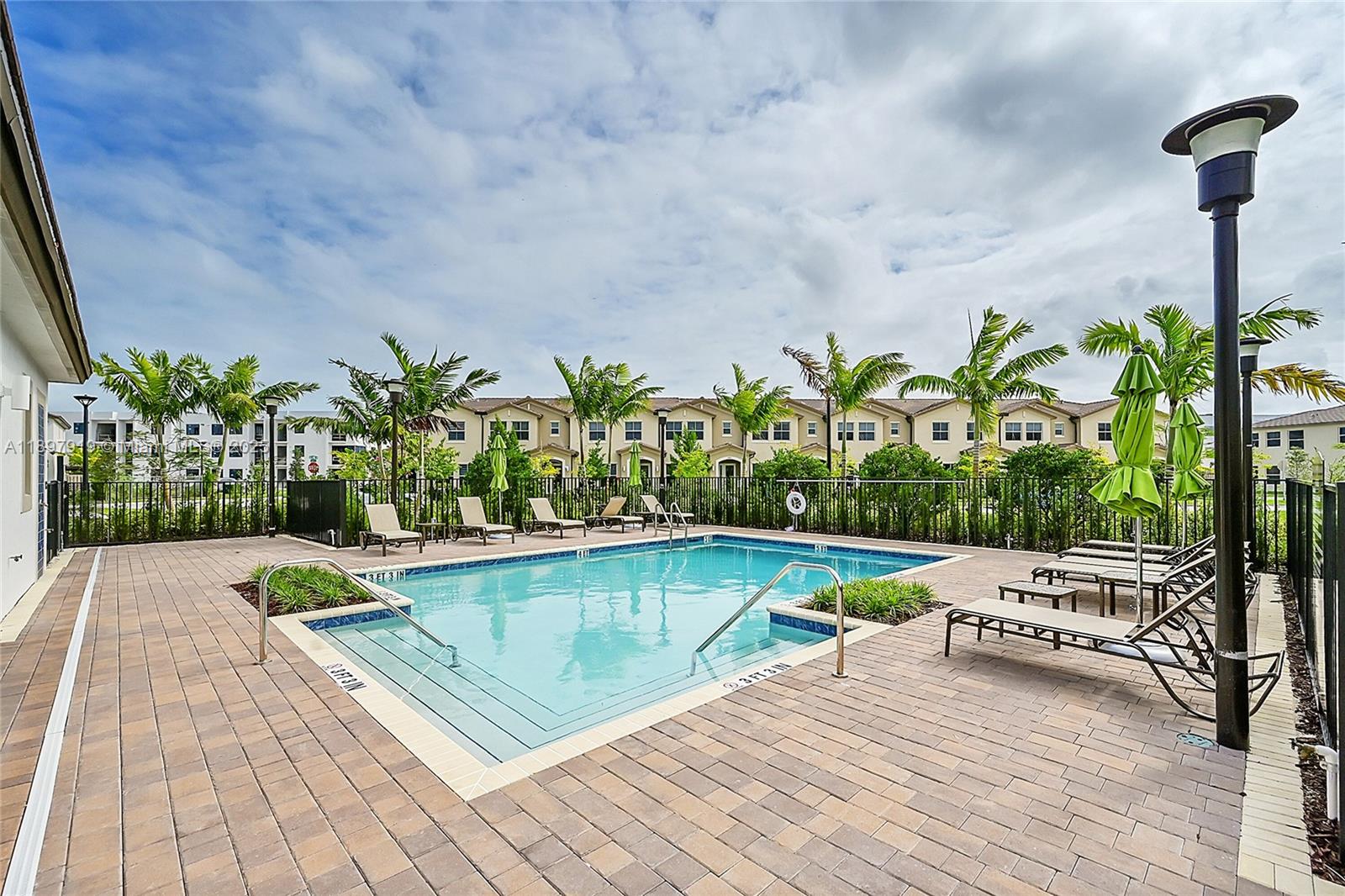 14832 Southwest 265th Street Homestead, FL 33032 - Photo 40 of 43 a swimming pool with outdoor seating and plants