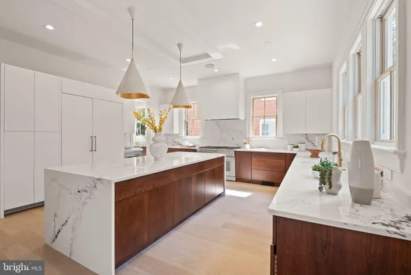 a kitchen with stainless steel appliances granite countertop a stove a sink and a wooden cabinets