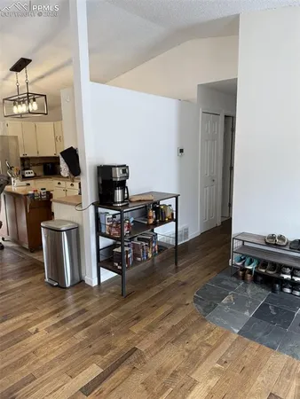 a living room with furniture a rug and a flat screen tv