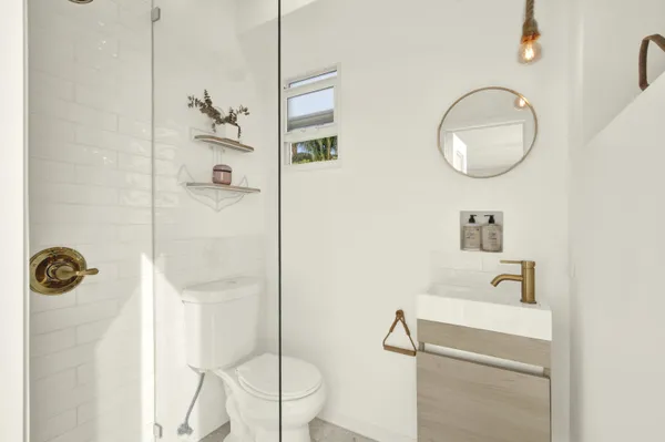 a bathroom with a sink a mirror and shower
