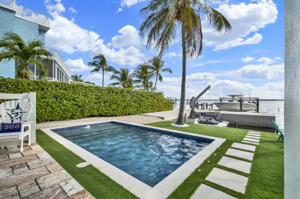 a view of house with outdoor space and swimming pool