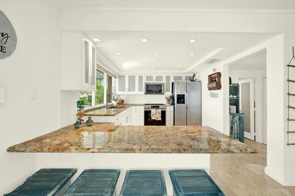 a view of a living room and kitchen