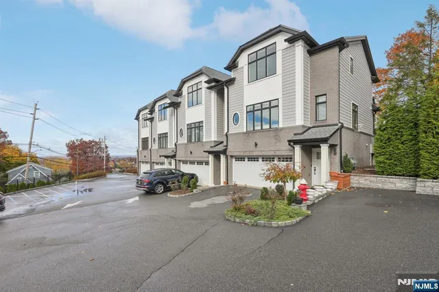 a view of a white house with a table and chairs