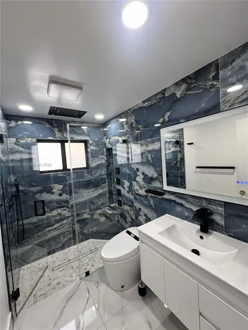 a bathroom with a toilet a sink and a shower