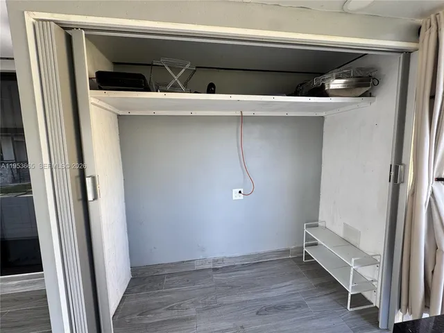 a view of a porch with furniture and a yard