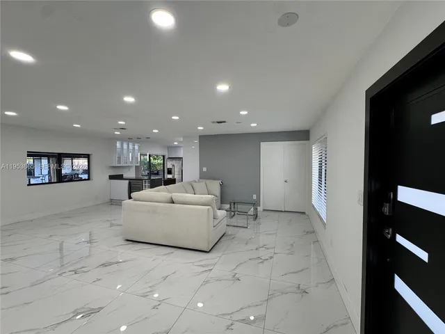 a living room with a couch and a large window