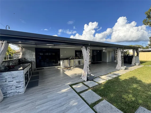 a view of a house with a yard patio and a garden