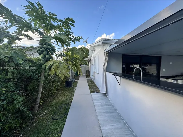 a backyard of a house with table and chairs