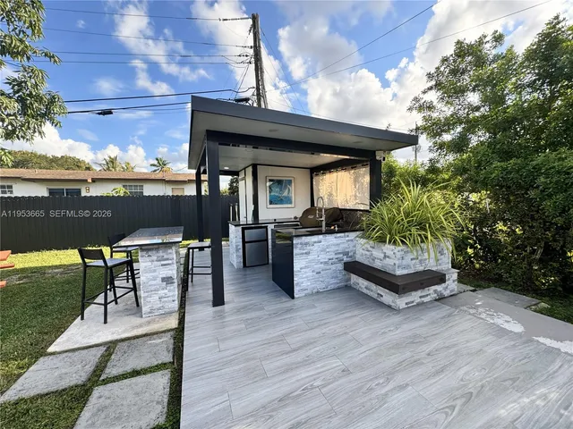 a kitchen with a stove a sink and a cabinets