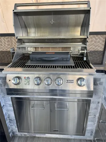 a view of a hallway with wooden floor and a living room