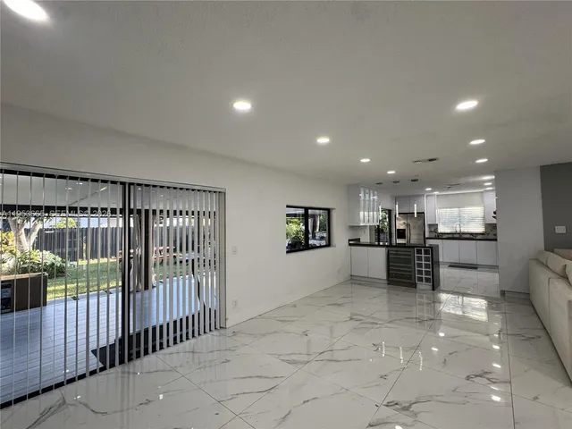 a view of kitchen with furniture and refrigerator
