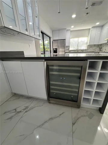 a kitchen with kitchen island sink and cabinets