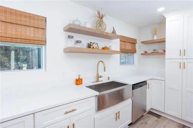 a kitchen with a sink a stove and cabinets