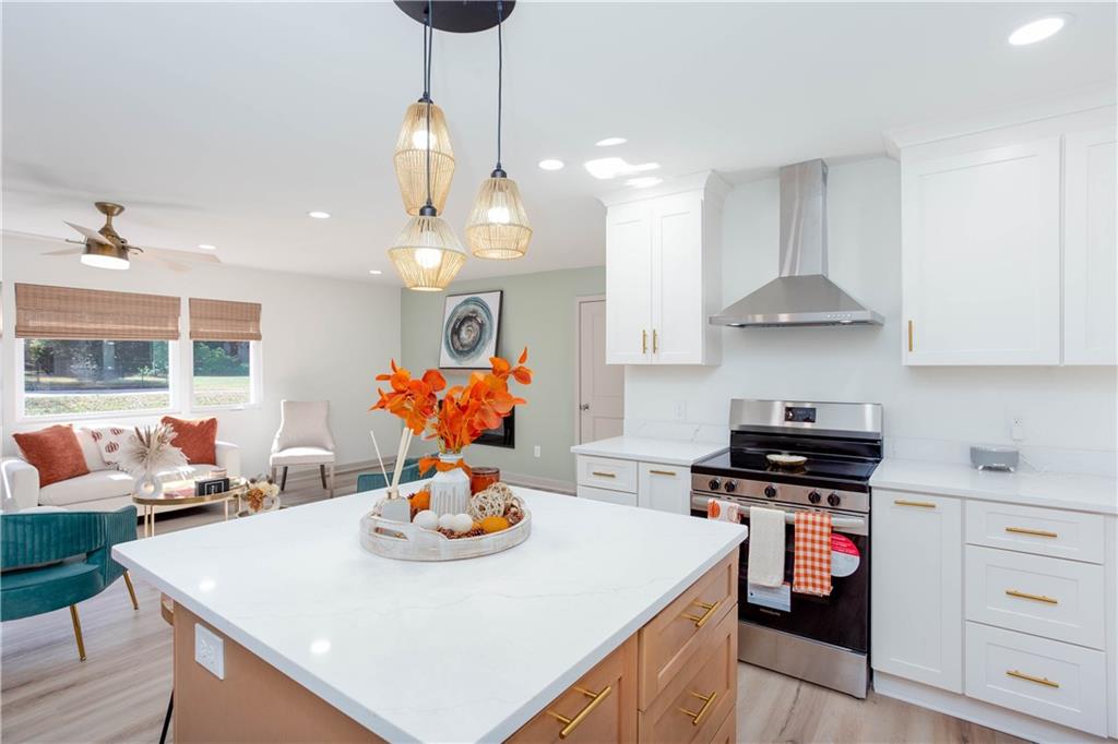 1560 North Columbia Place Decatur, GA 30032 - Photo 16 of 50 a kitchen with stainless steel appliances a stove a sink a dining table and chairs