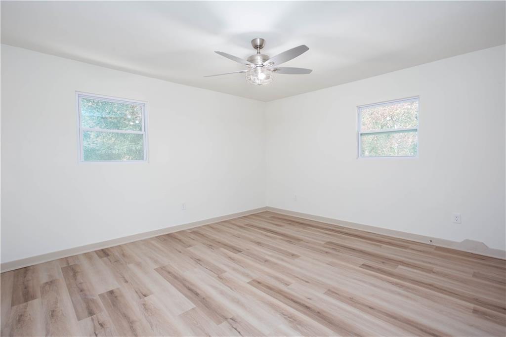 1560 North Columbia Place Decatur, GA 30032 - Photo 17 of 50 an empty room with wooden floor and windows