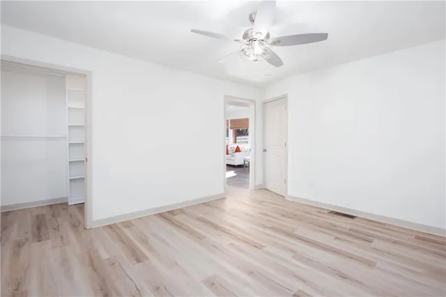 a view of an empty room with wooden floor