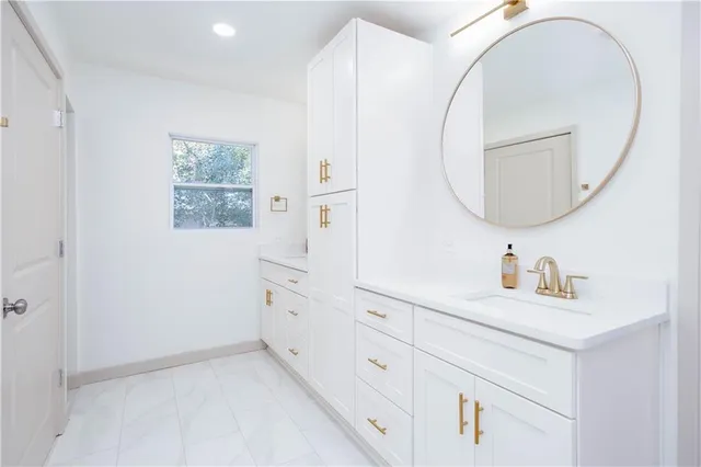 a bathroom with a sink and a mirror