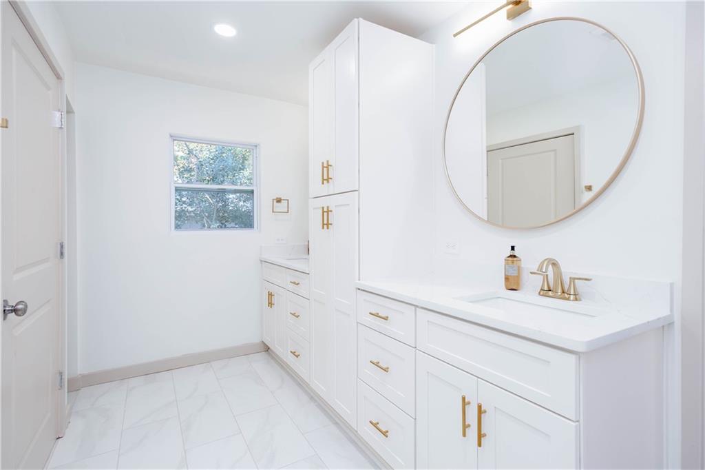 1560 North Columbia Place Decatur, GA 30032 - Photo 21 of 50 a bathroom with a sink and a mirror