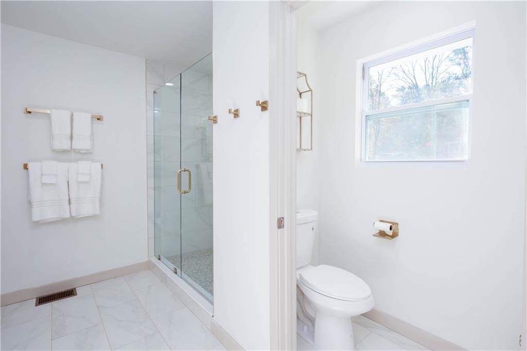 1560 North Columbia Place Decatur, GA 30032 - Photo 23 of 50 a bathroom with a toilet sink and shower