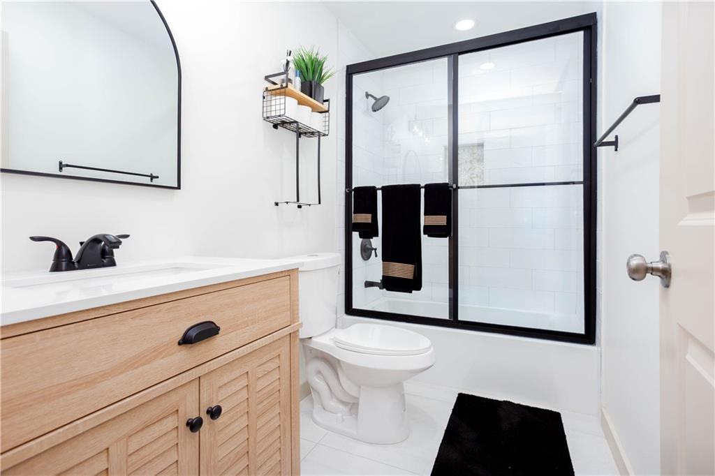 1560 North Columbia Place Decatur, GA 30032 - Photo 31 of 50 a bathroom with a sink a toilet and shower