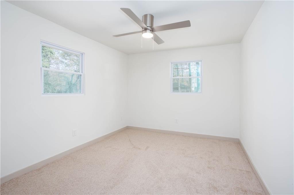 1560 North Columbia Place Decatur, GA 30032 - Photo 33 of 50 an empty room with a window and a ceiling fan