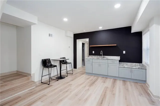 a view of a living room filled with furniture and a flat screen tv