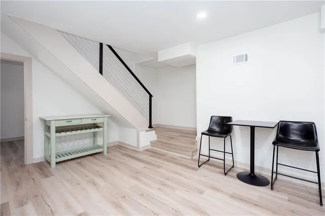 a view of entryway and hall with wooden floor