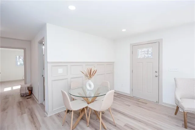 a view of a dining room with furniture and wooden floor