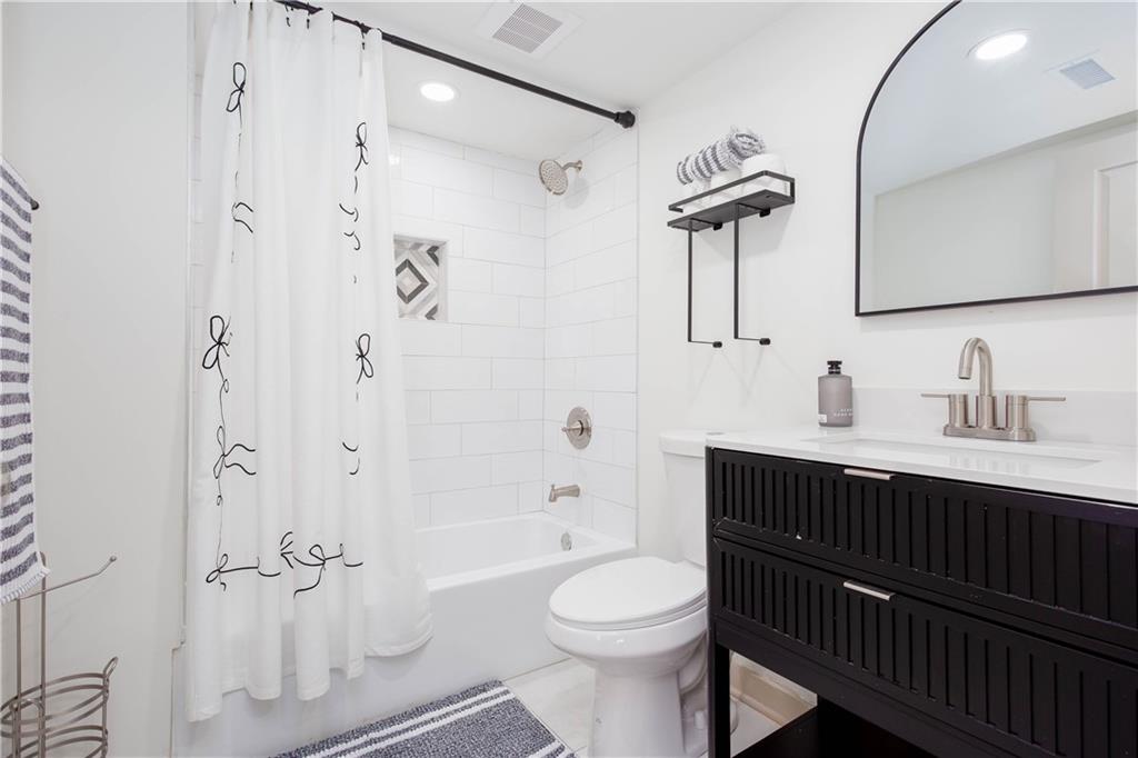 1560 North Columbia Place Decatur, GA 30032 - Photo 41 of 50 a bathroom with a sink a toilet and shower