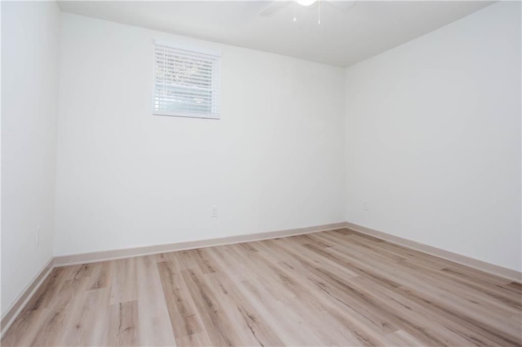 1560 North Columbia Place Decatur, GA 30032 - Photo 44 of 50 a view of an empty room with wooden floor and a window