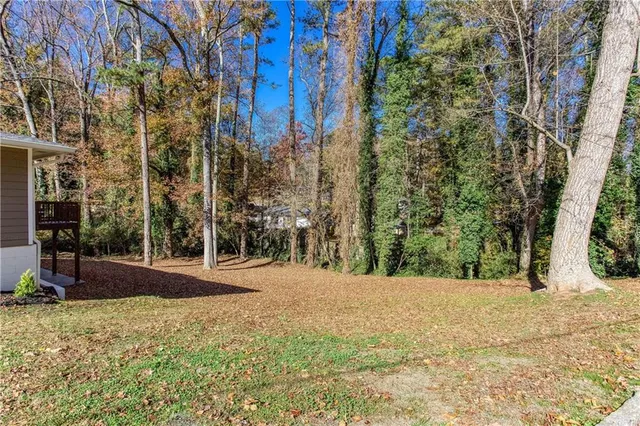 a view of large trees with a house