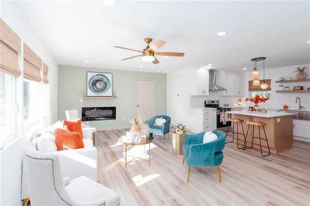 a living room with furniture and kitchen view