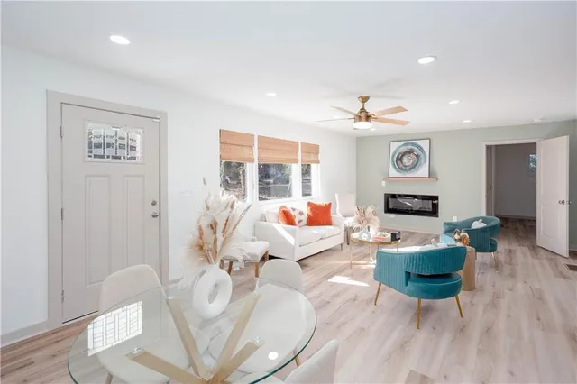 a living room with fireplace furniture and a wooden floor