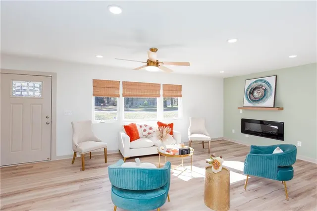 a living room with furniture and wooden floor