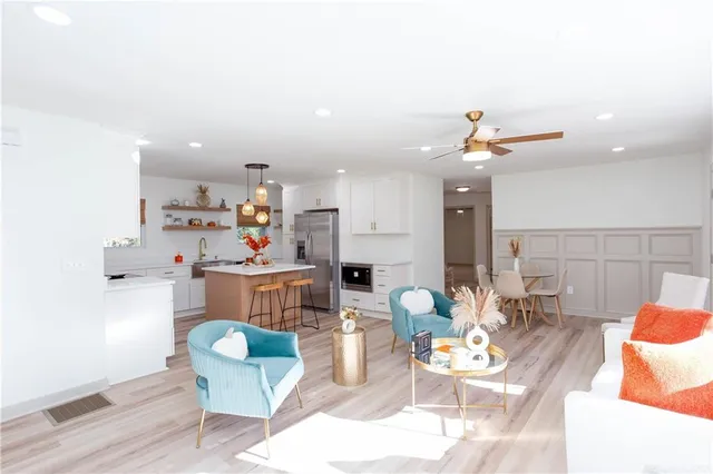 a living room with lots of furniture and kitchen view