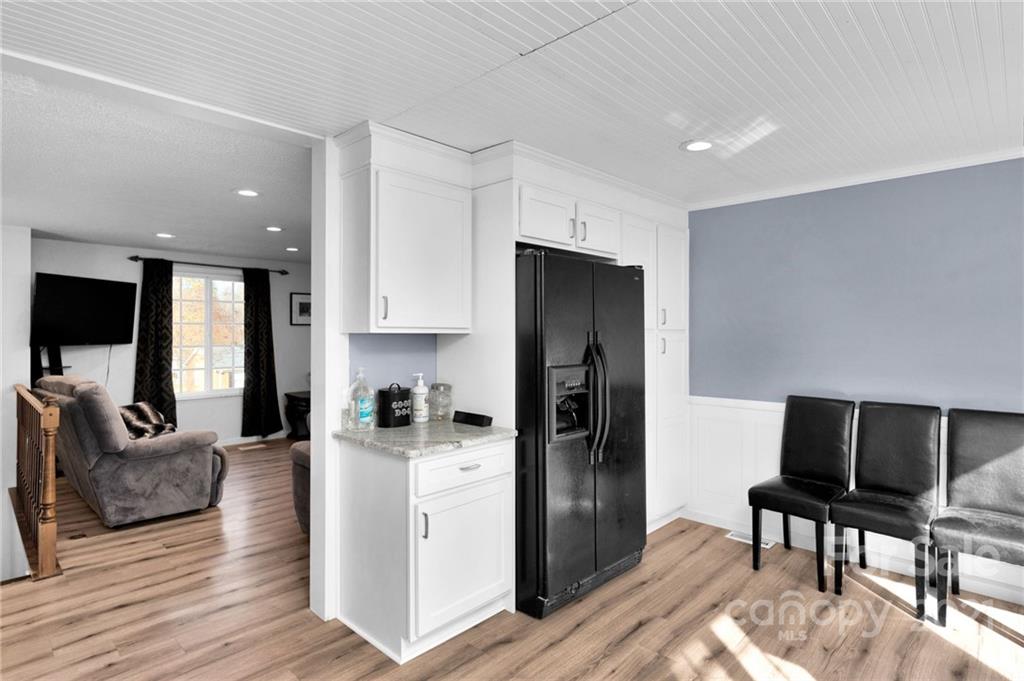 4800 Cheviot Road Charlotte, NC 28269 - Photo 13 of 34 a kitchen with stainless steel appliances kitchen island granite countertop a refrigerator and a stove top oven