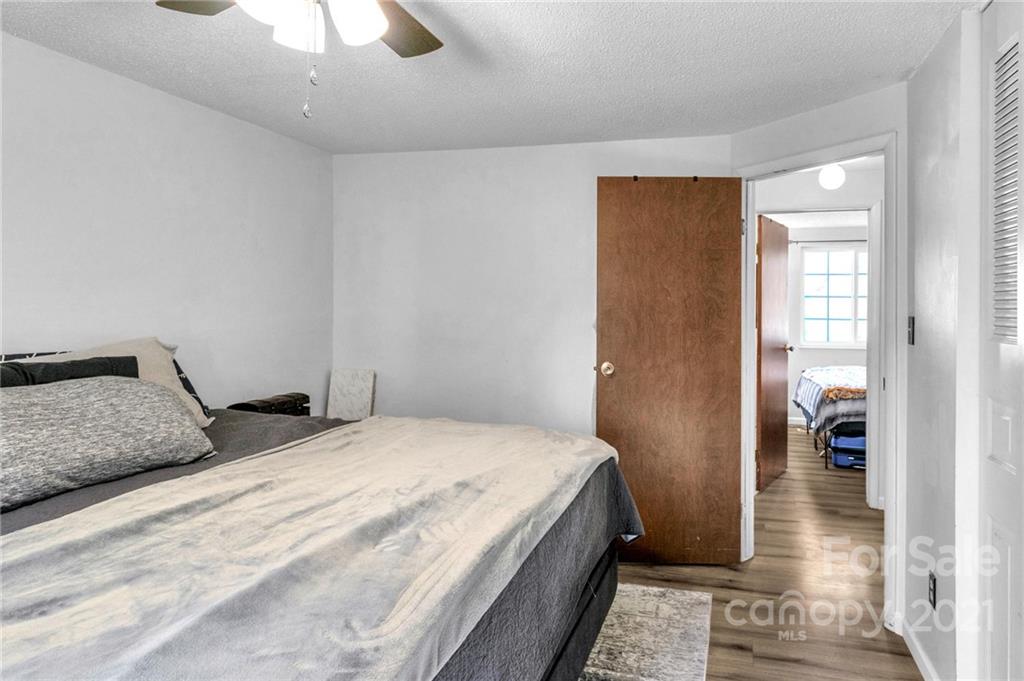 4800 Cheviot Road Charlotte, NC 28269 - Photo 15 of 34 a bedroom with a bed and a walk in closet