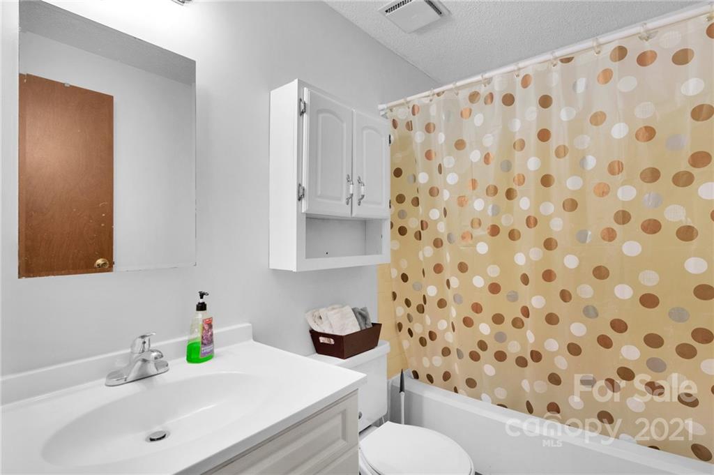 4800 Cheviot Road Charlotte, NC 28269 - Photo 16 of 34 a bathroom with a sink toilet and shower