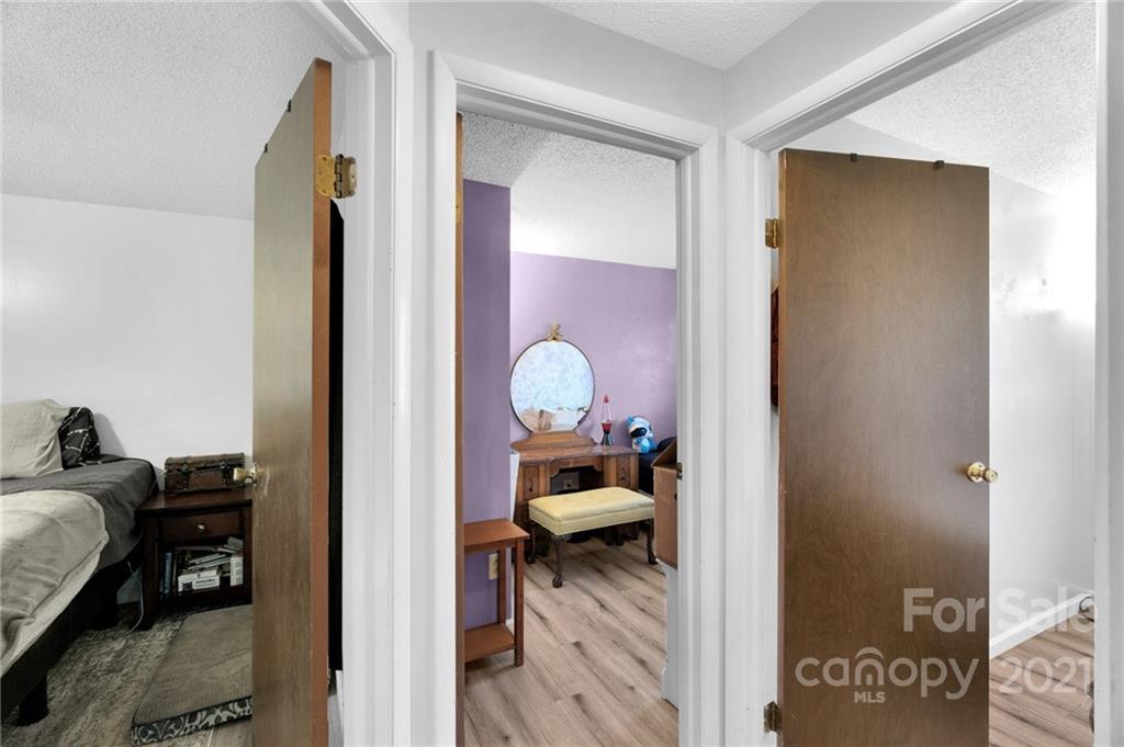 4800 Cheviot Road Charlotte, NC 28269 - Photo 20 of 34 a view of a bedroom with a bed and a mirror