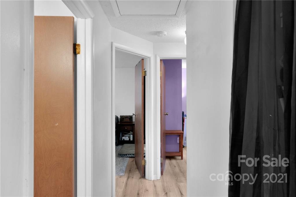 4800 Cheviot Road Charlotte, NC 28269 - Photo 21 of 34 a view of a hallway with wooden shelves