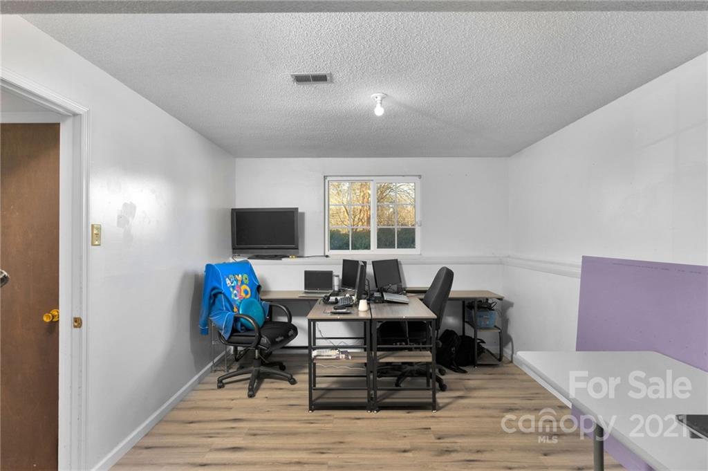4800 Cheviot Road Charlotte, NC 28269 - Photo 23 of 34 a view of a dining room with furniture window and wooden floor