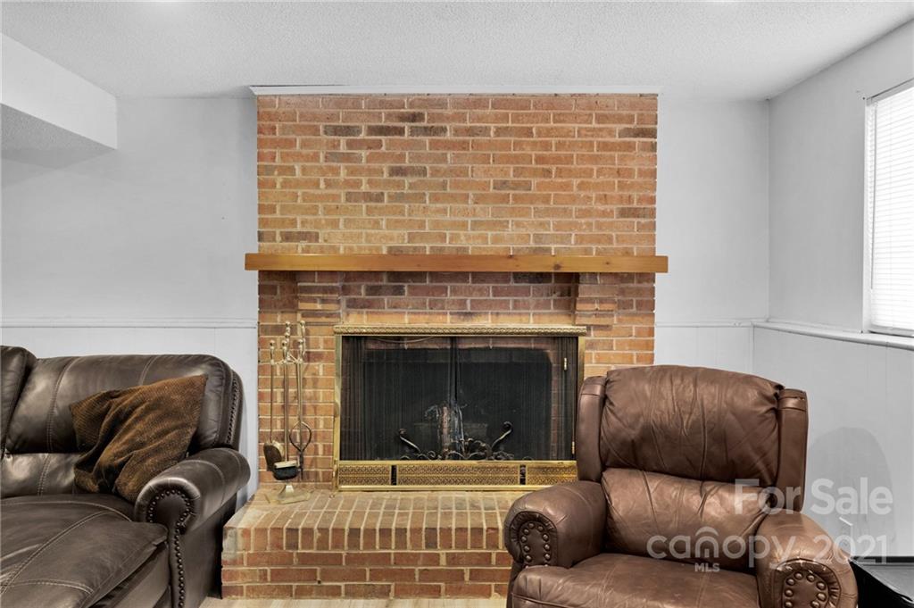 4800 Cheviot Road Charlotte, NC 28269 - Photo 25 of 34 a living room with furniture and a fireplace